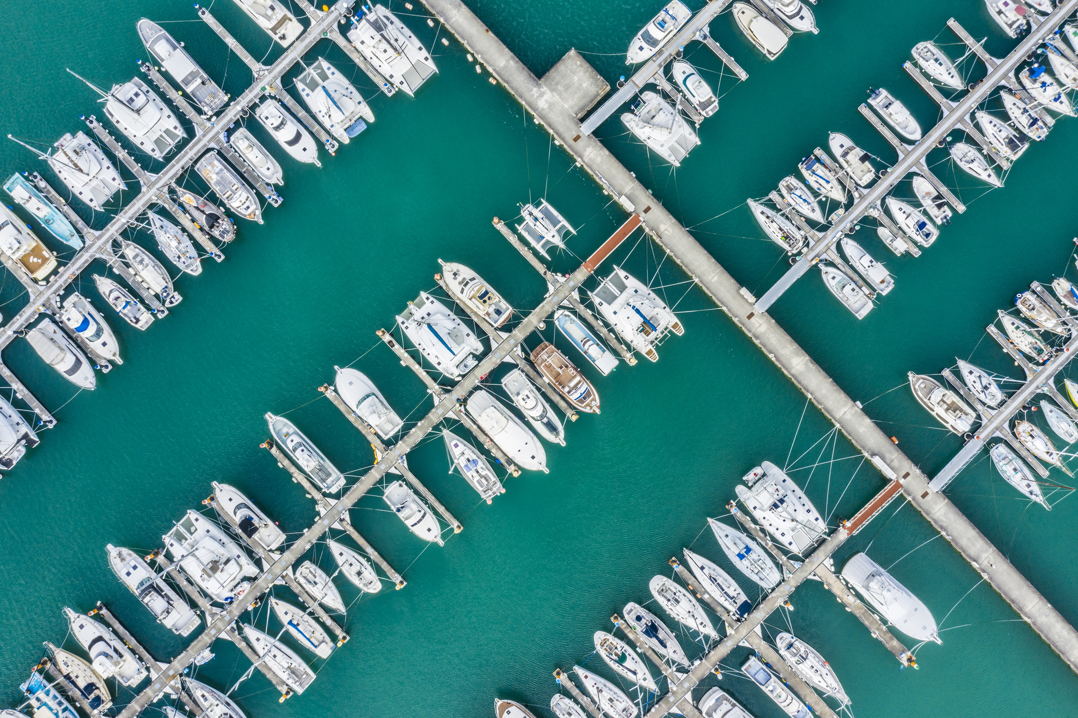 Aerial shooting of the resort area. A pier with many small boats anchoring.
